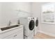 Laundry room with washer, dryer, and a utility sink at 7917 Mainsail Ln, Sarasota, FL 34240