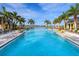 Large resort-style pool with palm trees and a clear view at 7917 Mainsail Ln, Sarasota, FL 34240