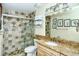 Bathroom with granite vanity, tiled shower, and built-in shelving at 797 Beach Rd # 305, Sarasota, FL 34242