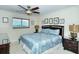 King-size bed, ceiling fan, and ample dresser space in the bedroom at 797 Beach Rd # 305, Sarasota, FL 34242