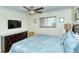 Main bedroom with king bed, dresser, and flat-screen TV at 797 Beach Rd # 305, Sarasota, FL 34242