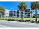 Building exterior showcasing landscaping and a paved road at 797 Beach Rd # 305, Sarasota, FL 34242