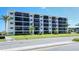 Multi-story building with balconies and lush landscaping at 797 Beach Rd # 305, Sarasota, FL 34242