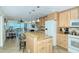 Well-equipped kitchen with granite island and modern cabinetry at 797 Beach Rd # 305, Sarasota, FL 34242