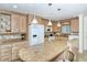 Modern kitchen with granite island, white appliances, and light wood cabinets at 797 Beach Rd # 305, Sarasota, FL 34242