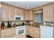 Kitchen features granite countertops, white appliances, and wood cabinets at 797 Beach Rd # 305, Sarasota, FL 34242