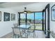 Screened lanai with table and chairs, offering stunning ocean views at 797 Beach Rd # 305, Sarasota, FL 34242