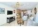 Open living room with kitchen view, neutral color palette, and tiled floors at 797 Beach Rd # 305, Sarasota, FL 34242