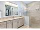 Spa-like bathroom features a walk-in shower, updated vanity, and modern fixtures at 8253 Grande Shores Dr, Sarasota, FL 34240