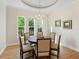 Formal dining room with hardwood floors, a round table, and natural light at 8253 Grande Shores Dr, Sarasota, FL 34240