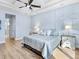 Bright main bedroom features light blue walls, hardwood floors, and a ceiling fan at 8253 Grande Shores Dr, Sarasota, FL 34240