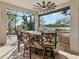 Enjoy this outdoor kitchen with bar seating and tropical-themed decor at 8253 Grande Shores Dr, Sarasota, FL 34240