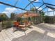 Relaxing patio furniture under a covered lanai at 8253 Grande Shores Dr, Sarasota, FL 34240