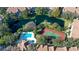 Aerial view showcasing the community pool, tennis court, and surrounding greenery at 850 S Tamiami Trl # 408, Sarasota, FL 34236