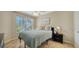 Comfortable bedroom with a window view and coastal-themed decorations and tile flooring at 850 S Tamiami Trl # 408, Sarasota, FL 34236