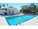 Community pool featuring clear blue water and ample lounge seating at 850 S Tamiami Trl # 408, Sarasota, FL 34236