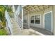 Condo exterior featuring stairs leading to unit 408 with light blue door and windows at 850 S Tamiami Trl # 408, Sarasota, FL 34236