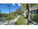 Landscaped walkway leading to residences, showcasing well-maintained grounds and trees at 850 S Tamiami Trl # 408, Sarasota, FL 34236