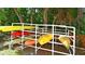 Kayak storage rack holding multiple colorful kayaks surrounded by trees at 850 S Tamiami Trl # 408, Sarasota, FL 34236