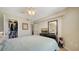 Main bedroom featuring closet, dresser, and window with a view to outdoor greenery at 850 S Tamiami Trl # 408, Sarasota, FL 34236