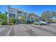 Exterior of building with parking lot, landscaping and view of units with balconies at 850 S Tamiami Trl # 408, Sarasota, FL 34236