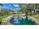 Beautiful water view with green pond and building in background at 850 S Tamiami Trl # 408, Sarasota, FL 34236