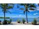 Picturesque water view framed by palm trees, showcasing the serene waterfront setting at 850 S Tamiami Trl # 408, Sarasota, FL 34236