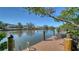 Scenic view of waterfront with wooden dock, posts, ladder and seating at 850 S Tamiami Trl # 408, Sarasota, FL 34236