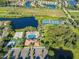 Aerial view of community pool, tennis courts, and lake at 9109 Winter Harbour Way, Bradenton, FL 34212