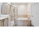 Bathroom featuring a large walk-in shower and a separate soaking tub at 9109 Winter Harbour Way, Bradenton, FL 34212