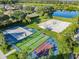 Aerial view of community recreation area with bocce ball, volleyball, and basketball courts at 9109 Winter Harbour Way, Bradenton, FL 34212