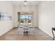 Dining area with a round glass-top table and blue cushioned chairs at 9109 Winter Harbour Way, Bradenton, FL 34212