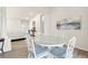 Bright dining room with white table and chairs, hardwood floors, and view to living area at 9109 Winter Harbour Way, Bradenton, FL 34212