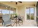 Relaxing lanai with screened enclosure, wicker furniture, and view of the lake at 9109 Winter Harbour Way, Bradenton, FL 34212