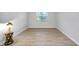 Empty bedroom with wood-look tile floors and a window at 972 La Costa Cir # 5, Sarasota, FL 34237