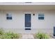 Condo entrance with dark gray door and landscaping at 972 La Costa Cir # 5, Sarasota, FL 34237