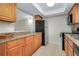 Well-lit kitchen with wood cabinets and granite counters at 972 La Costa Cir # 5, Sarasota, FL 34237