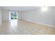 Bright living room with tile floors and sliding glass doors leading to a patio at 972 La Costa Cir # 5, Sarasota, FL 34237