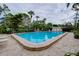 Inviting community pool with lounge chairs for sunbathing at 972 La Costa Cir # 5, Sarasota, FL 34237