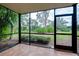 Screened porch overlooking a lush, green backyard at 972 La Costa Cir # 5, Sarasota, FL 34237