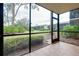 Screened porch with view of community landscape and trees at 972 La Costa Cir # 5, Sarasota, FL 34237