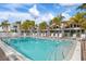 Community pool with lounge chairs and surrounding buildings at 100 73Rd St # 104A, Holmes Beach, FL 34217