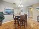 Simple dining area with wood floors and lighting fixture at 10190 Imperial Point W Dr # 16, Largo, FL 33774