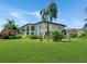 Condo building showcasing manicured lawn and palm trees at 10190 Imperial Point W Dr # 16, Largo, FL 33774