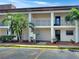 Two-story condo building with palm trees and parking at 10190 Imperial Point W Dr # 16, Largo, FL 33774