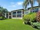 Condo building with lush lawn and tropical landscaping at 10190 Imperial Point W Dr # 16, Largo, FL 33774