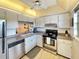 Modern kitchen with stainless steel appliances and view to living room at 10190 Imperial Point W Dr # 16, Largo, FL 33774