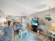 Open living space with hardwood floors, neutral decor, and access to dining area at 10190 Imperial Point W Dr # 16, Largo, FL 33774