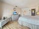 Main bedroom with king bed, dresser, and access to bathroom at 10190 Imperial Point W Dr # 16, Largo, FL 33774