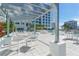 Resort-style pool area with lounge chairs and outdoor kitchen at 111 S Pineapple Ave # 708, Sarasota, FL 34236